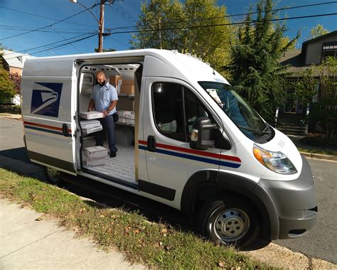 A USPS delivery driver delivering a package